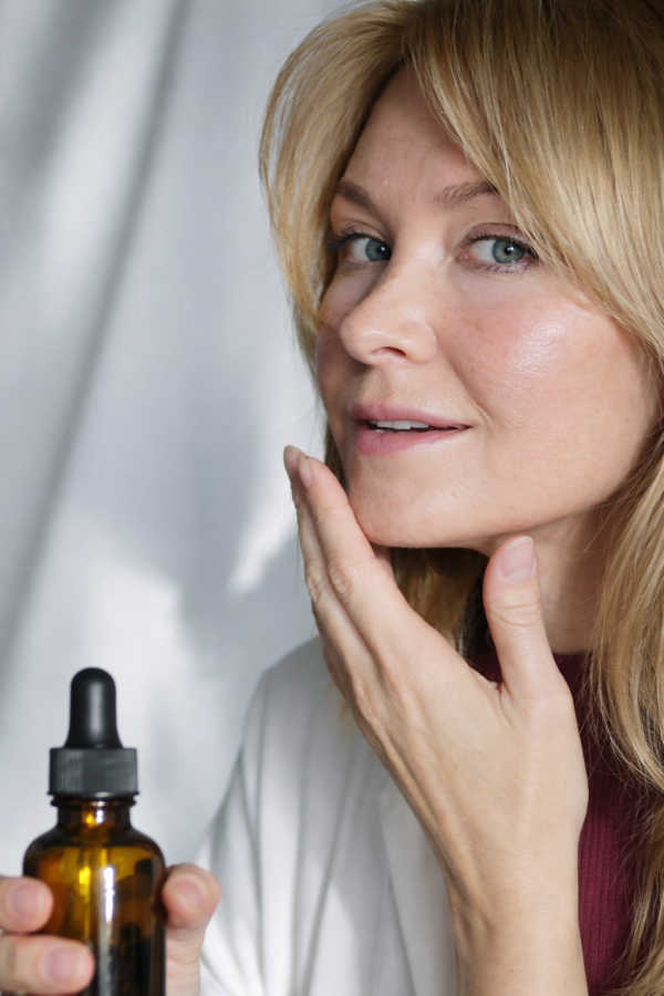 Skincare Over 40: Simple Routine Guide 40+ Woman applying face serum as part of a simple skincare routine